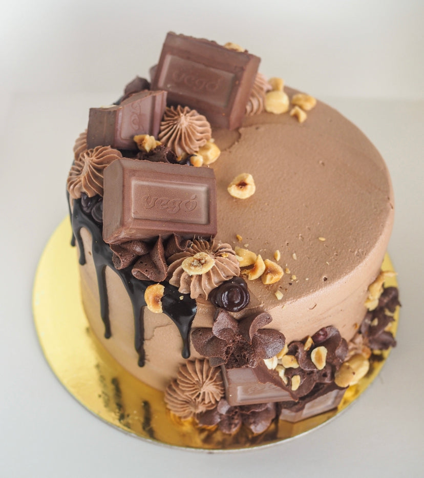 delicious chocolate two-tier birthday cake with gold decorations. candy bar  16688713 Stock Photo at Vecteezy